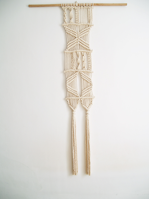 Contemporary macrame Ashley tapestry. sections with different knot designs. Narrow and elongated on wooden support