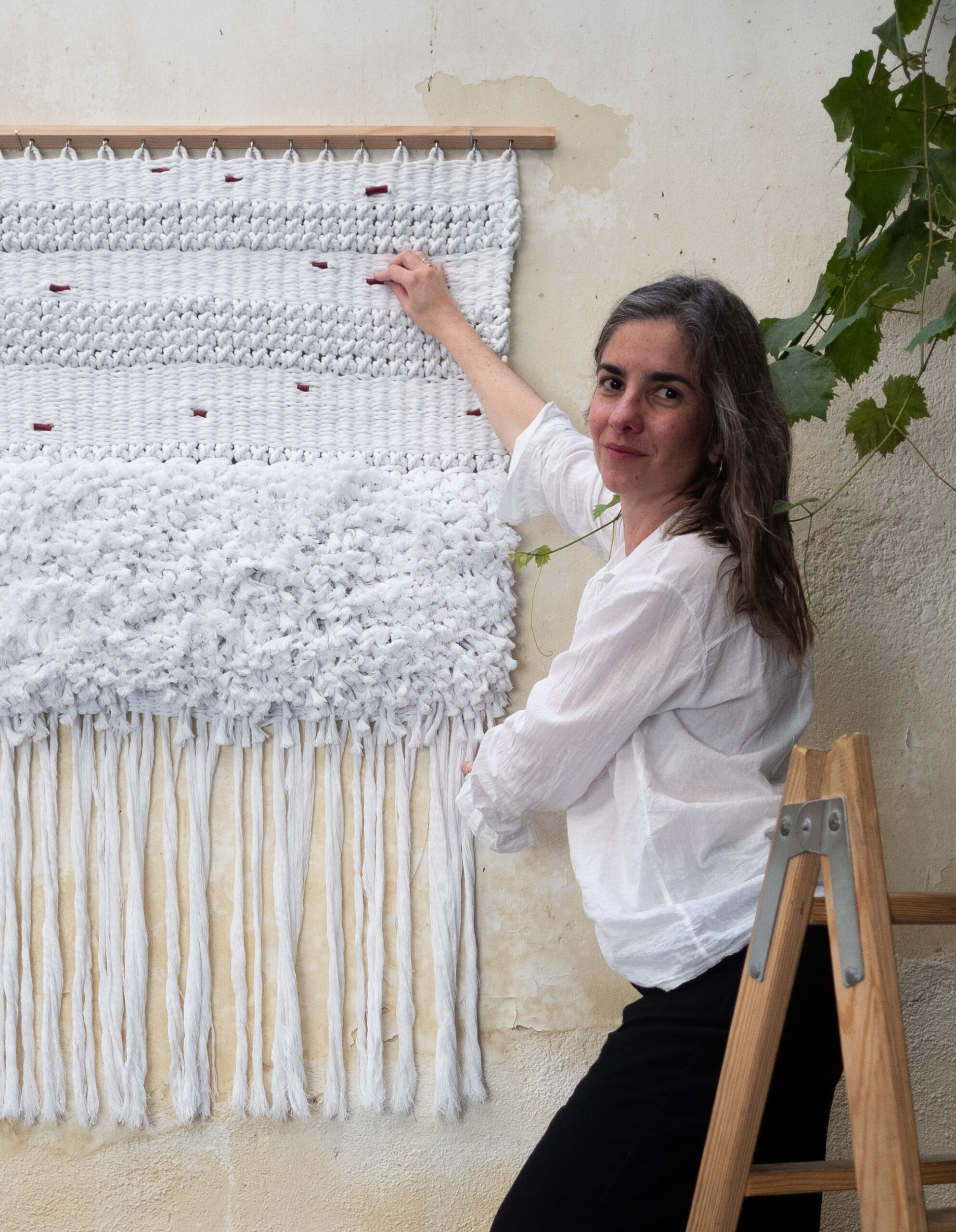 Fiber art sculpture with red textile details and natural wood — Malimbus Studio